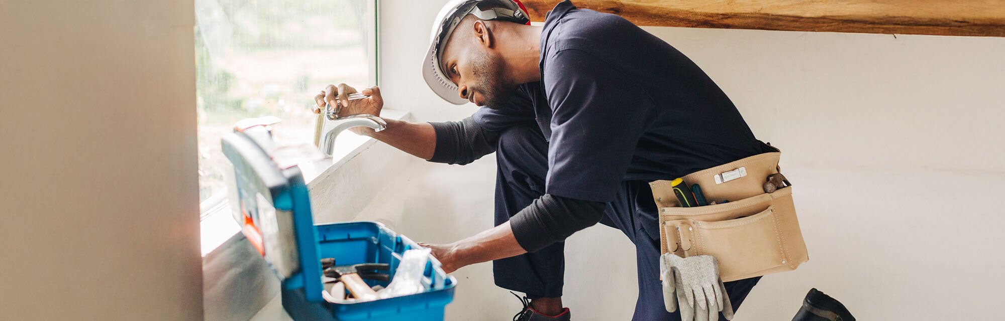 Plumber is installing a faucet.