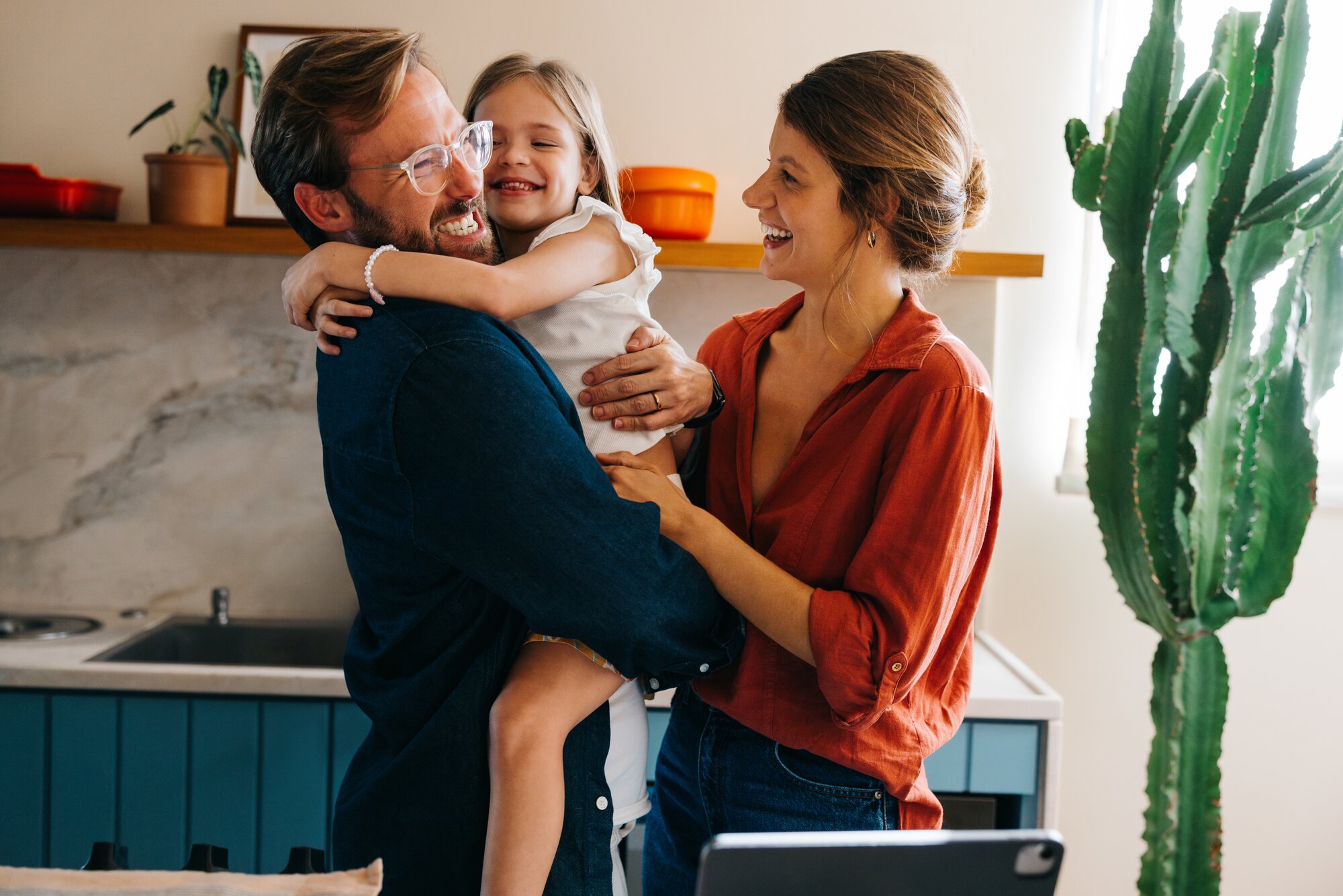 Two parents and a young child together.