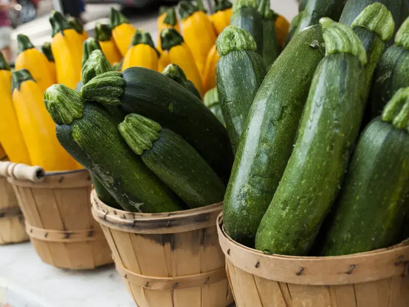 Baskets of yellow and green zucchini