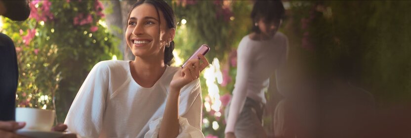 woman-holding-purple-heated-device-outdoors
