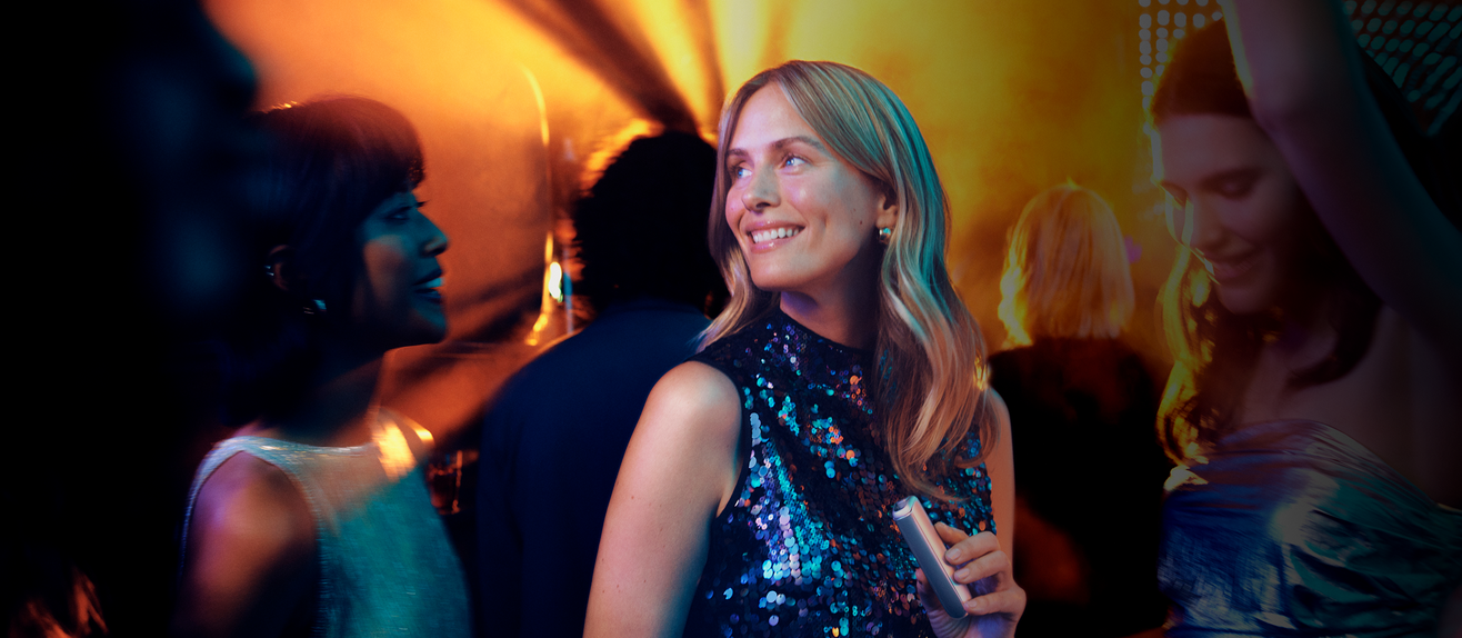 woman-holding-device-at-night-party