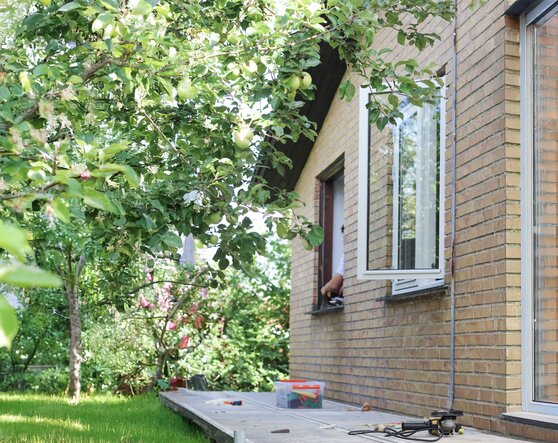 Homeowner installing a window