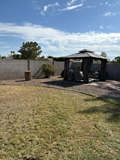 After: residential driveway and gravel landscaping beneath an overcast sky