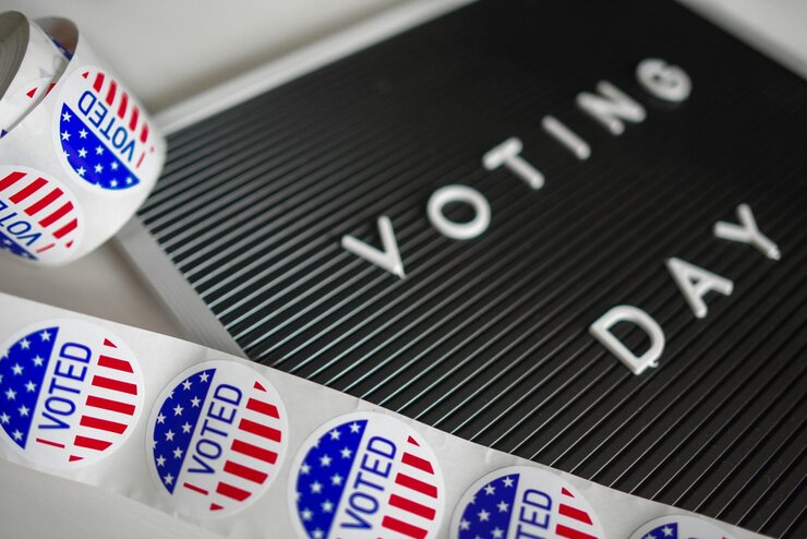 “Voting Day” sign with “I Voted” stickers.