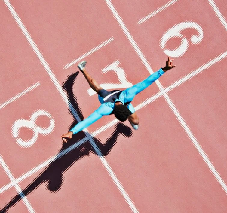 Birds eye view of man running over a finishing line