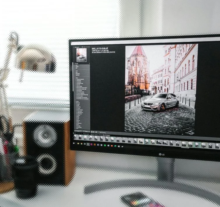 Computer with a photo editing software on screen with a car image