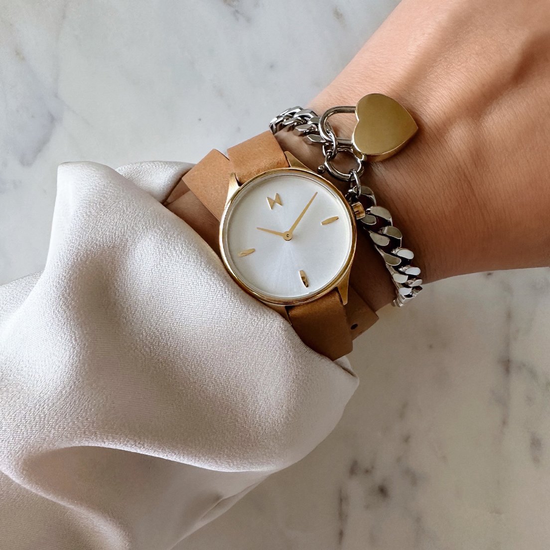 MVMT Reina leather watch and heartlock bracelet on wrist