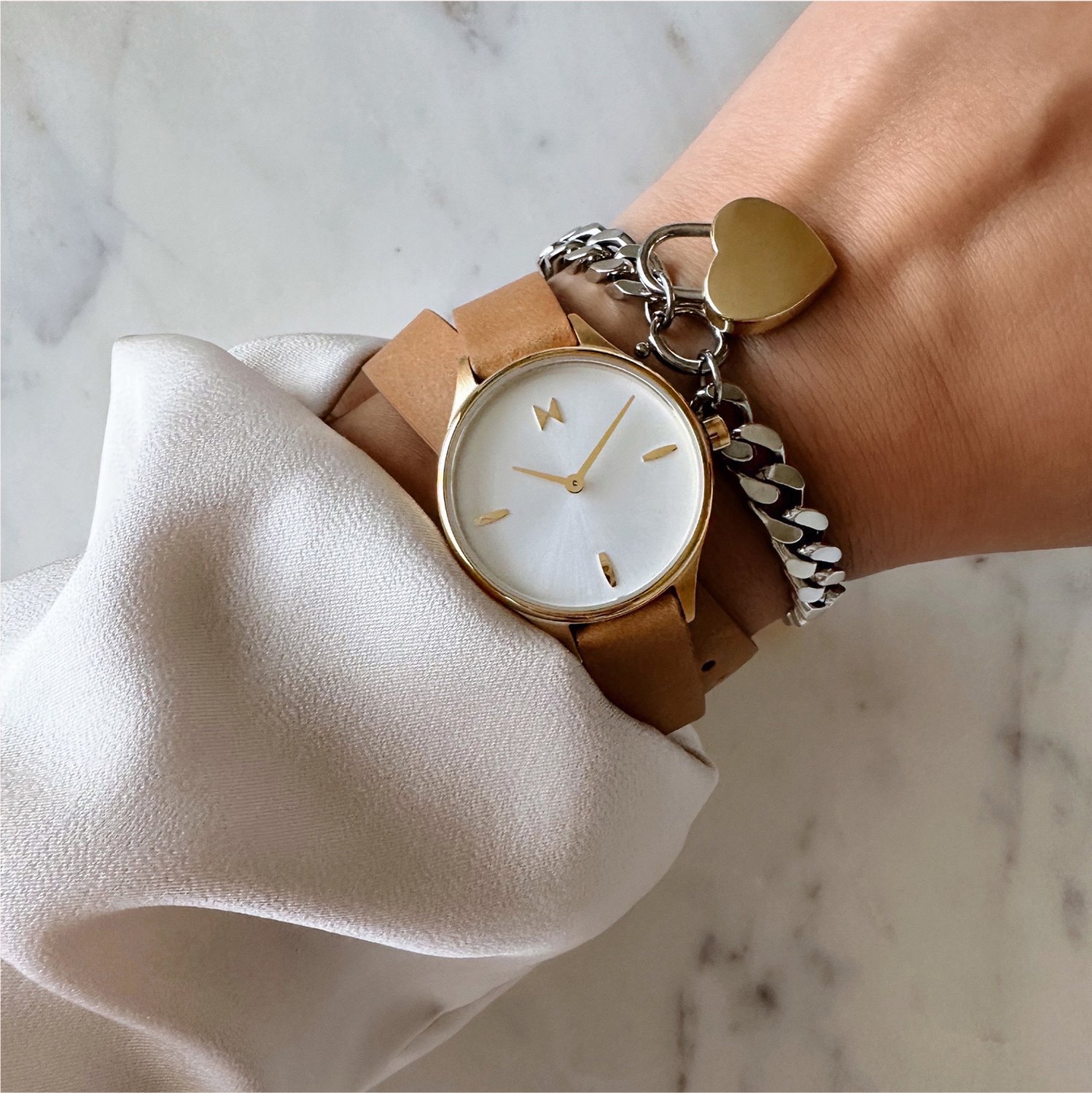 MVMT Reina leather watch and heartlock bracelet on wrist