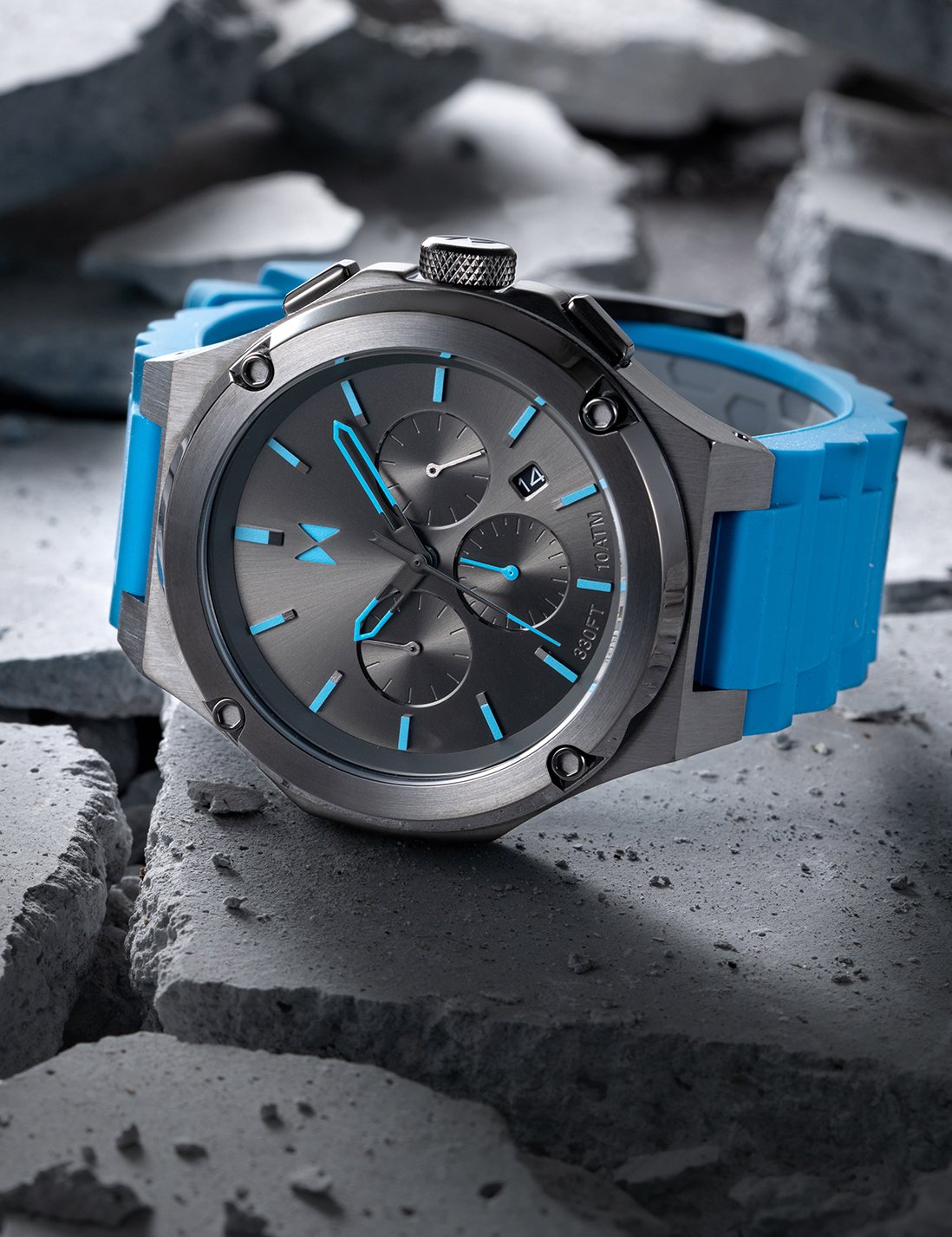 MVMT watch with blue strap and black face lying on cracked concrete
