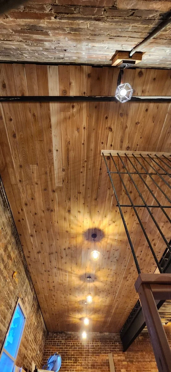 Renovated interior with wood ceiling and exposed brick