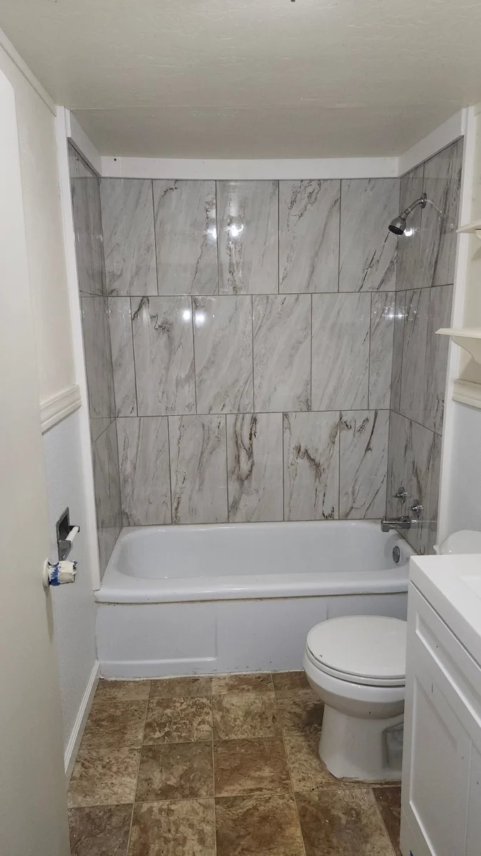 Bathroom renovation with marble-look tile surround