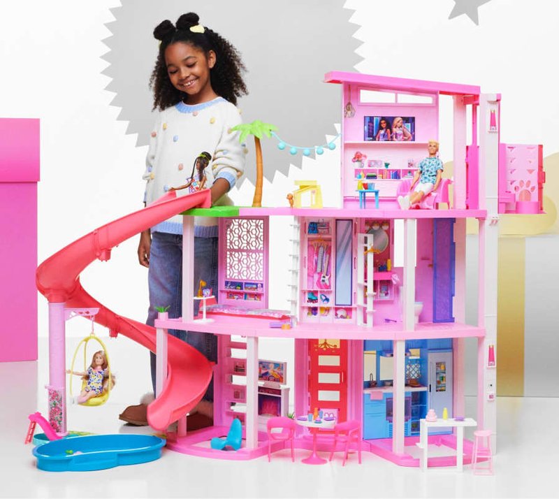 Fisher-Price toys including a colorful robot, a penguin, and a food stand.