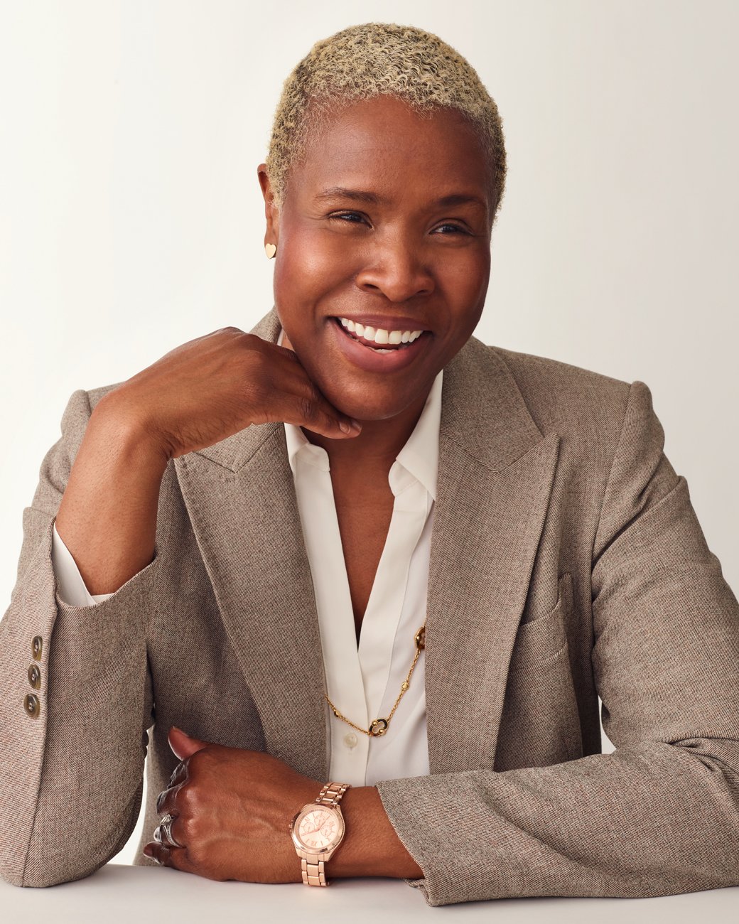 Headshot of a smiling professional woman who works for Atria in a blazer with a white background