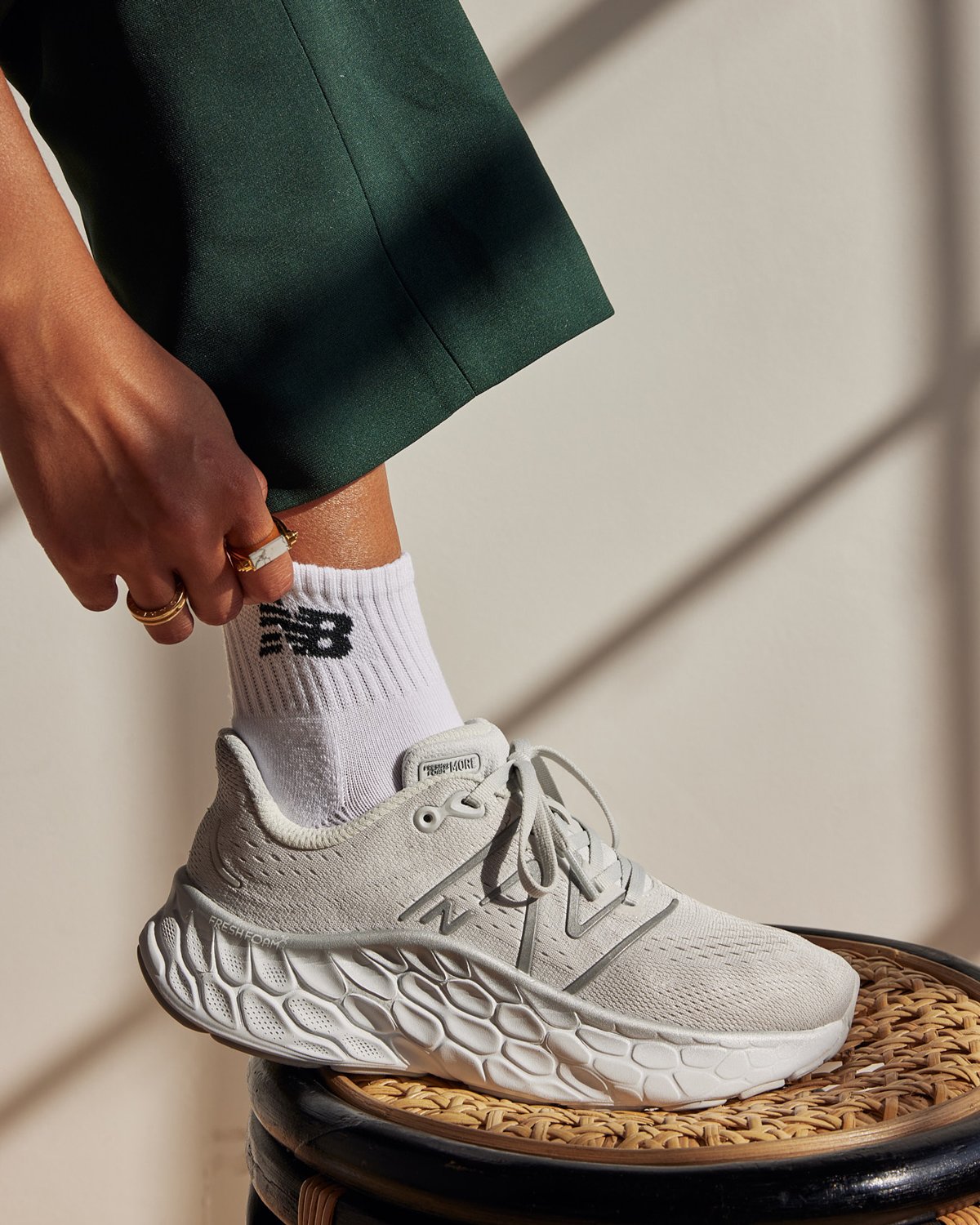Photo production and sponsored post of the white New Balance Socks and off-white New Balance lifted shoe with laces