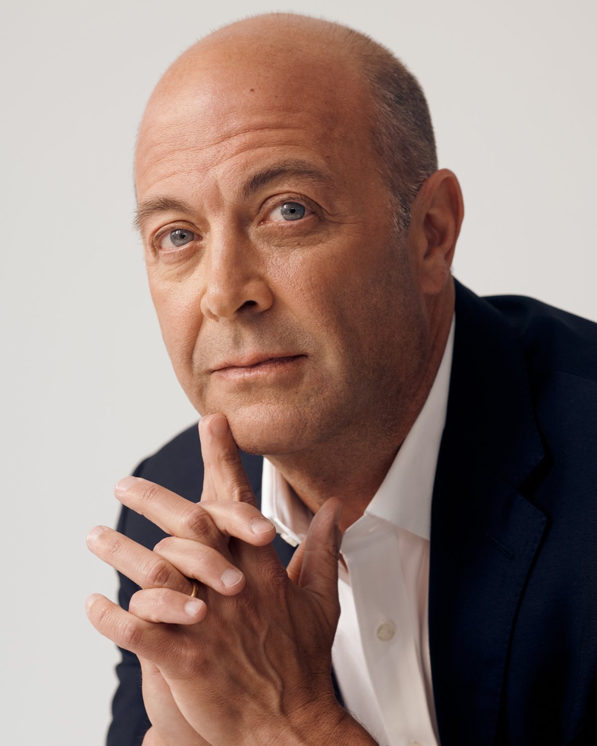 Headshot of a professional man in a suit looking directly at the camera, working for Atria