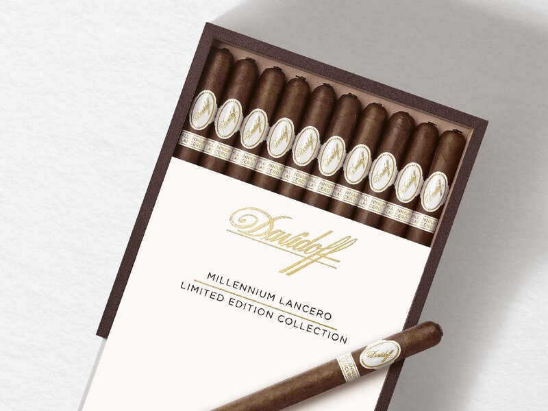 Opened box with ten Davidoff Millennium Lancero cigars inside and one placed on top.