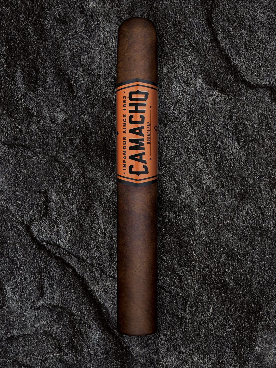 Camacho Broadleaf Cigar on a rock