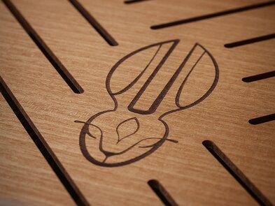 A close-up of the rabbit Masterpiece Humidor with a logo of the rabbit on it. 