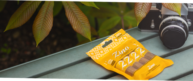 Zino Nicaragua Short Torpedo Fresh Pack on a park bench next to a analogue photo camera.