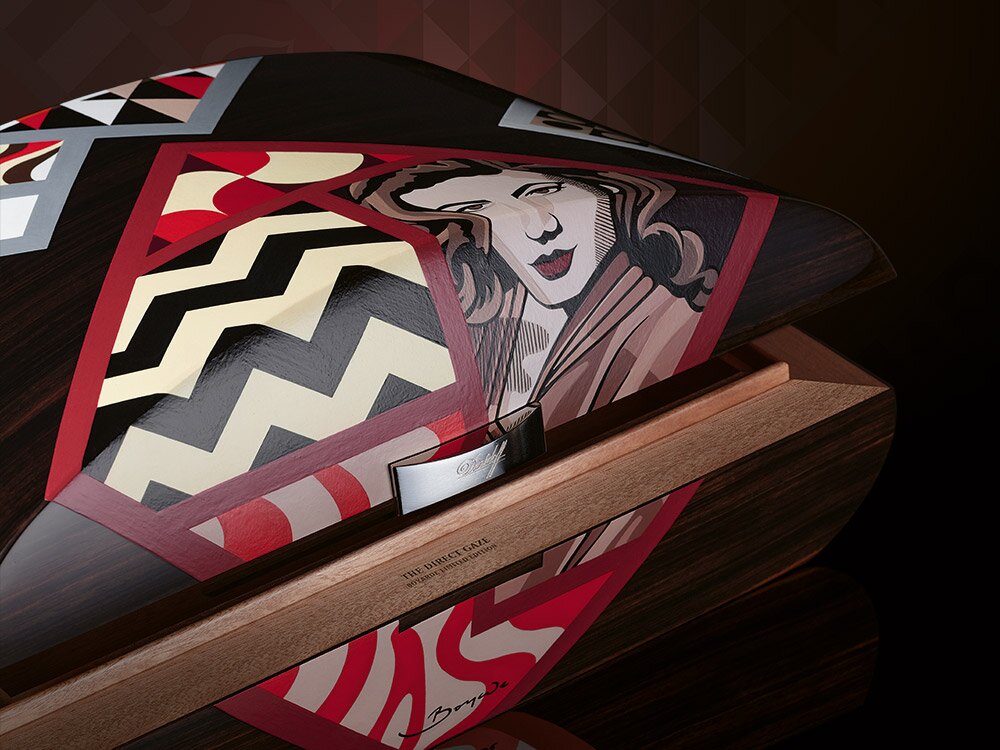 The Davidoff & Boyarde Masterpiece Humidor The Direct Gaze with two perfecto cigars placed in front of it. 