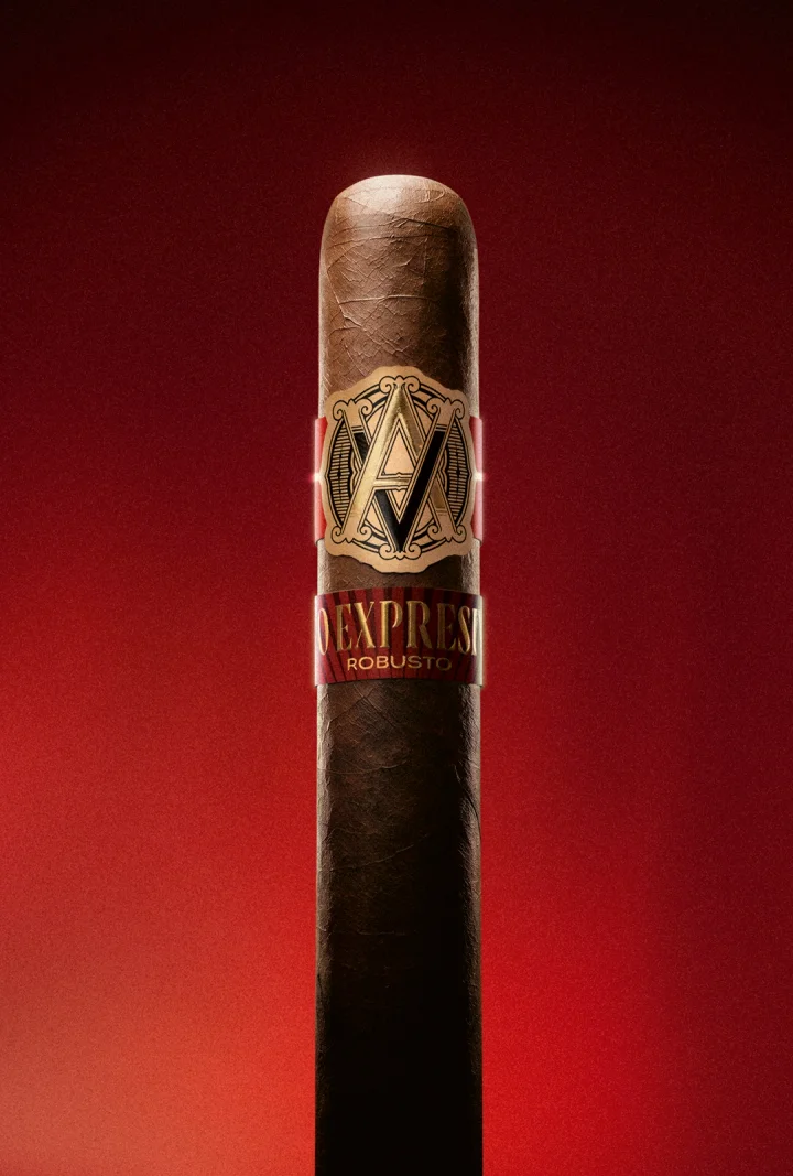 A farmer harvesting a large tobacco leaf. 