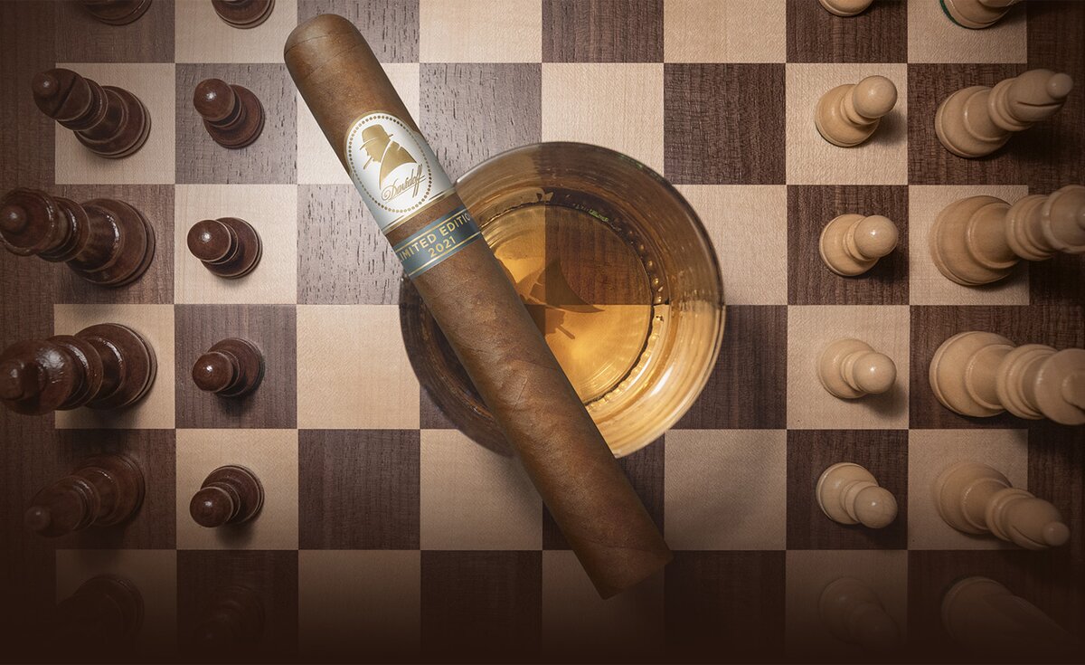 Top view of Davidoff Winston Churchill Limited Edition 2021 cigar on a spirit glass on a chessboard. 