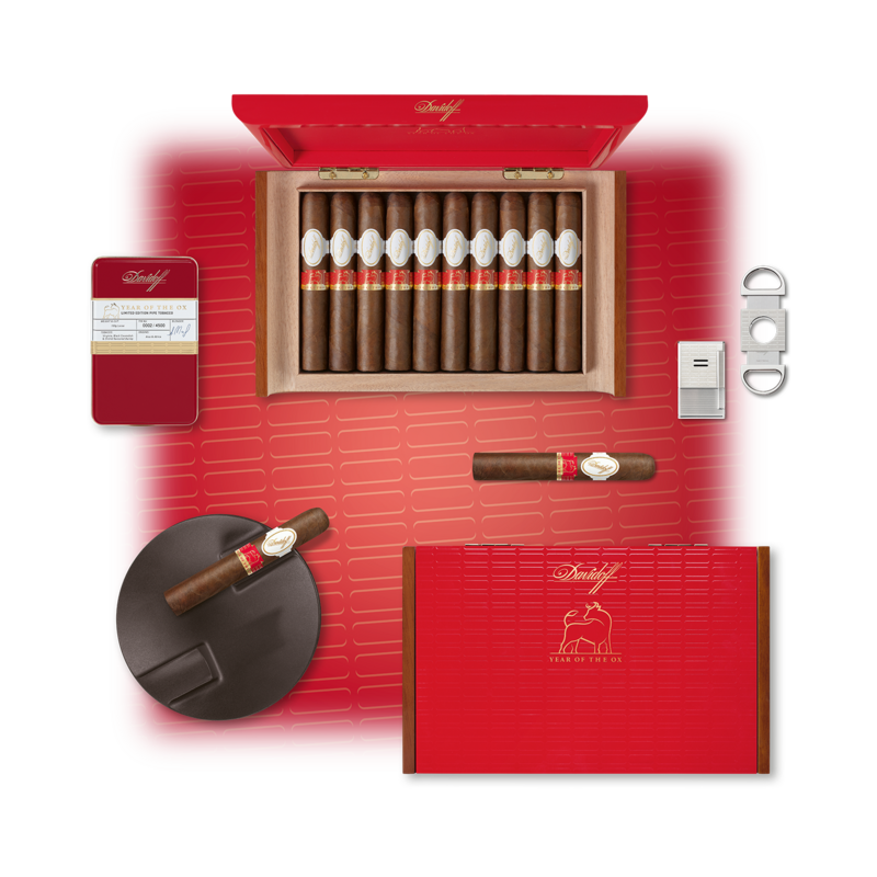 The 8 different formats of the Davidoff Year of the Ox Limited Edition 2021 line shown next to one another. Davidoff Year Of The Ox 2021 Limited Edition cigar box with cigar cutter, ashtray, jet flame lighter and tobacco, picture from above. 