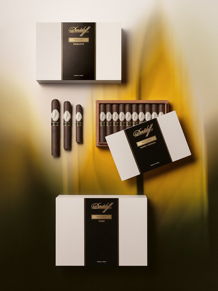 The Davidoff Maduro box opened with ten cigars visible next to another closed box and the Toro, Robusto and the Short Corona cigar of the line. 