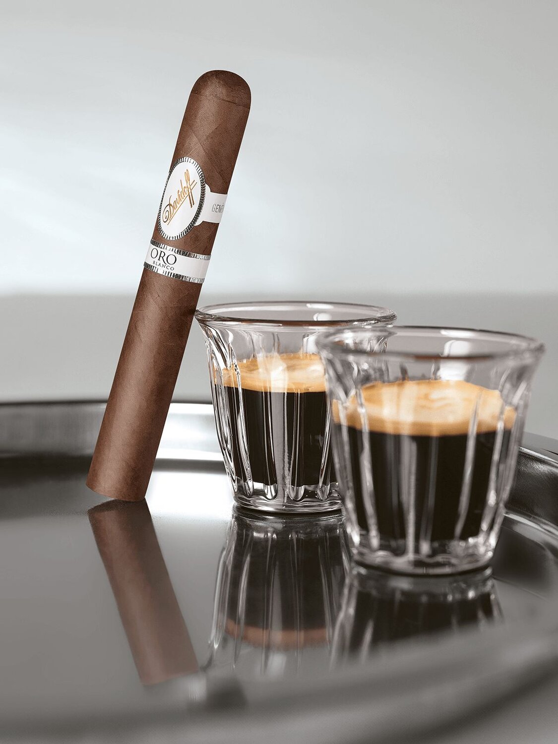 The Davidoff Oro Blanco Special Reserve 111 Years next to a black ivory coffee.