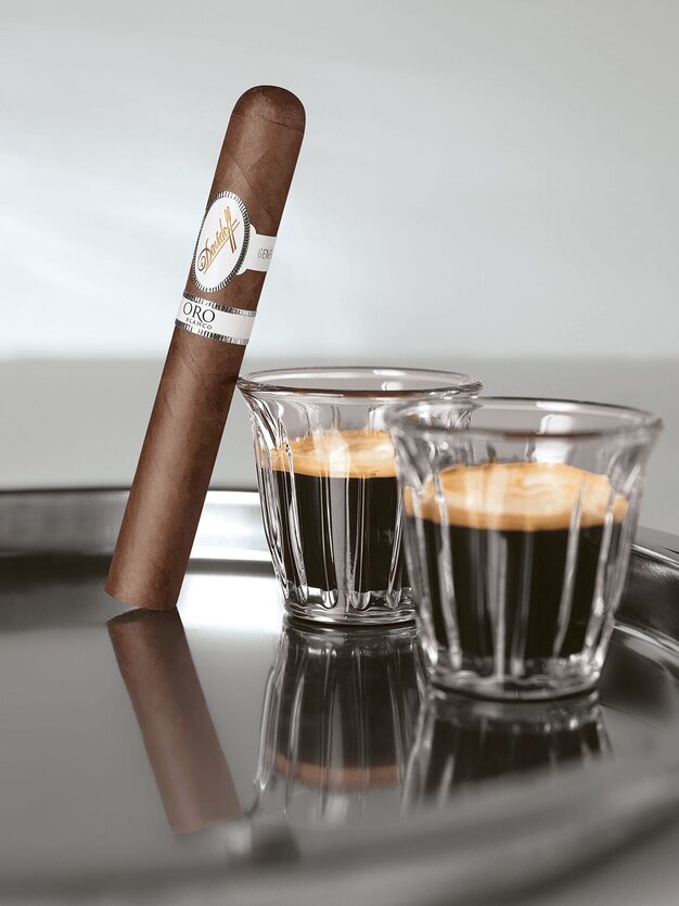 The Davidoff Oro Blanco Special Reserve 111 Years next to a Black Ivory coffee. 