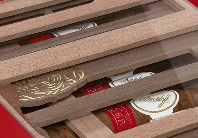 4 Trays of the Davidoff Year of the Rabbit Flagship Exclusive with cigars inside, placed next to their box.