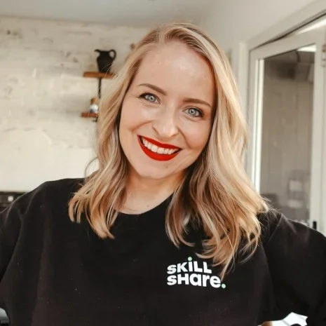 A headshot of Maggie Stara, designer, marketer, and Skillshare teacher.