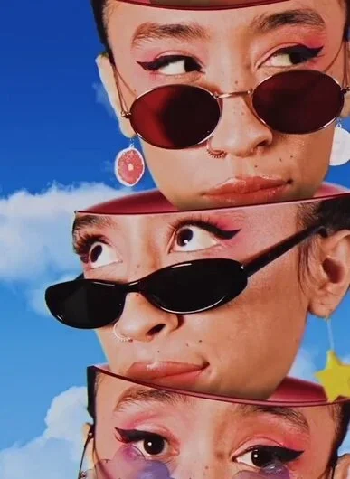 Movie poster featuring a woman in sunglasses, exuding confidence and style against a vibrant background.