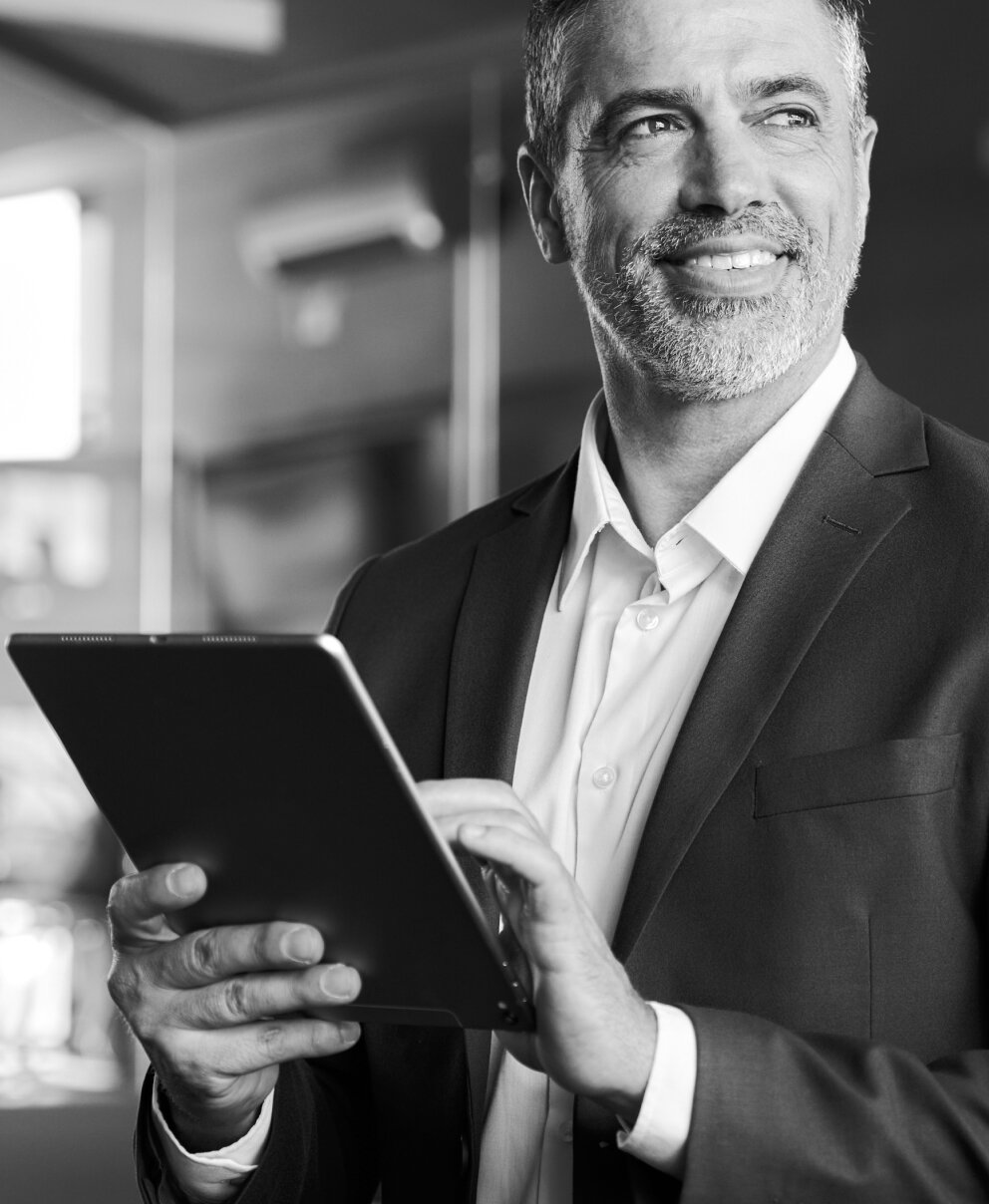 Smiling man using tablet.