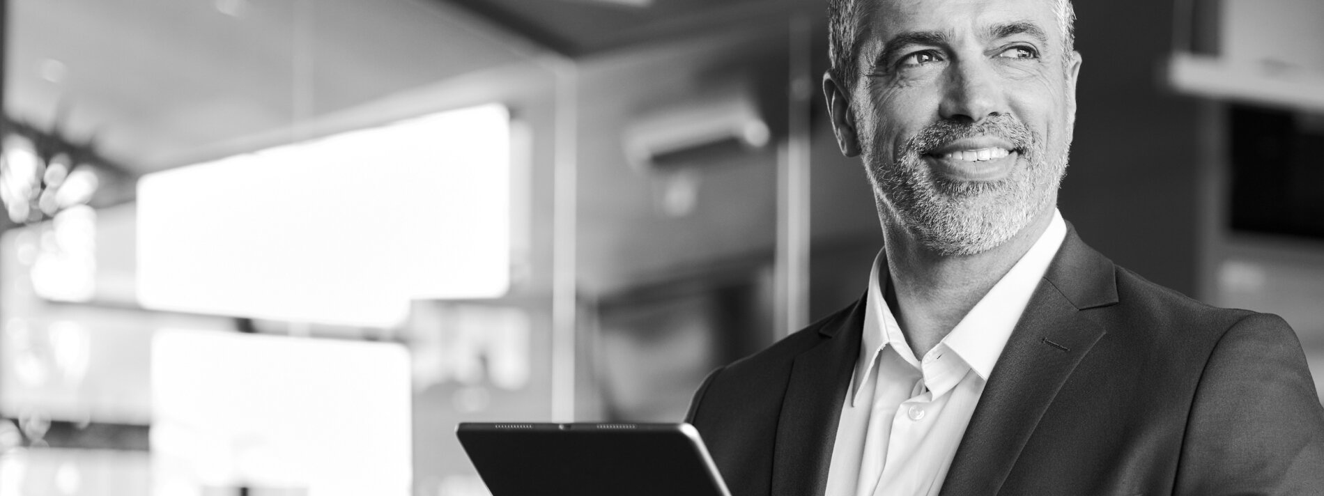 Smiling man using tablet.
