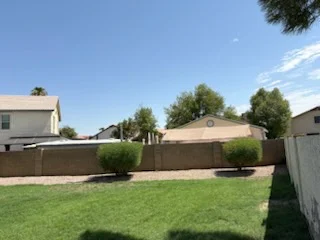 Freshly mowed backyard lawn beside a privacy fence