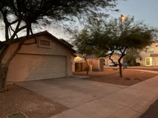 Residential driveway and front yard at dusk