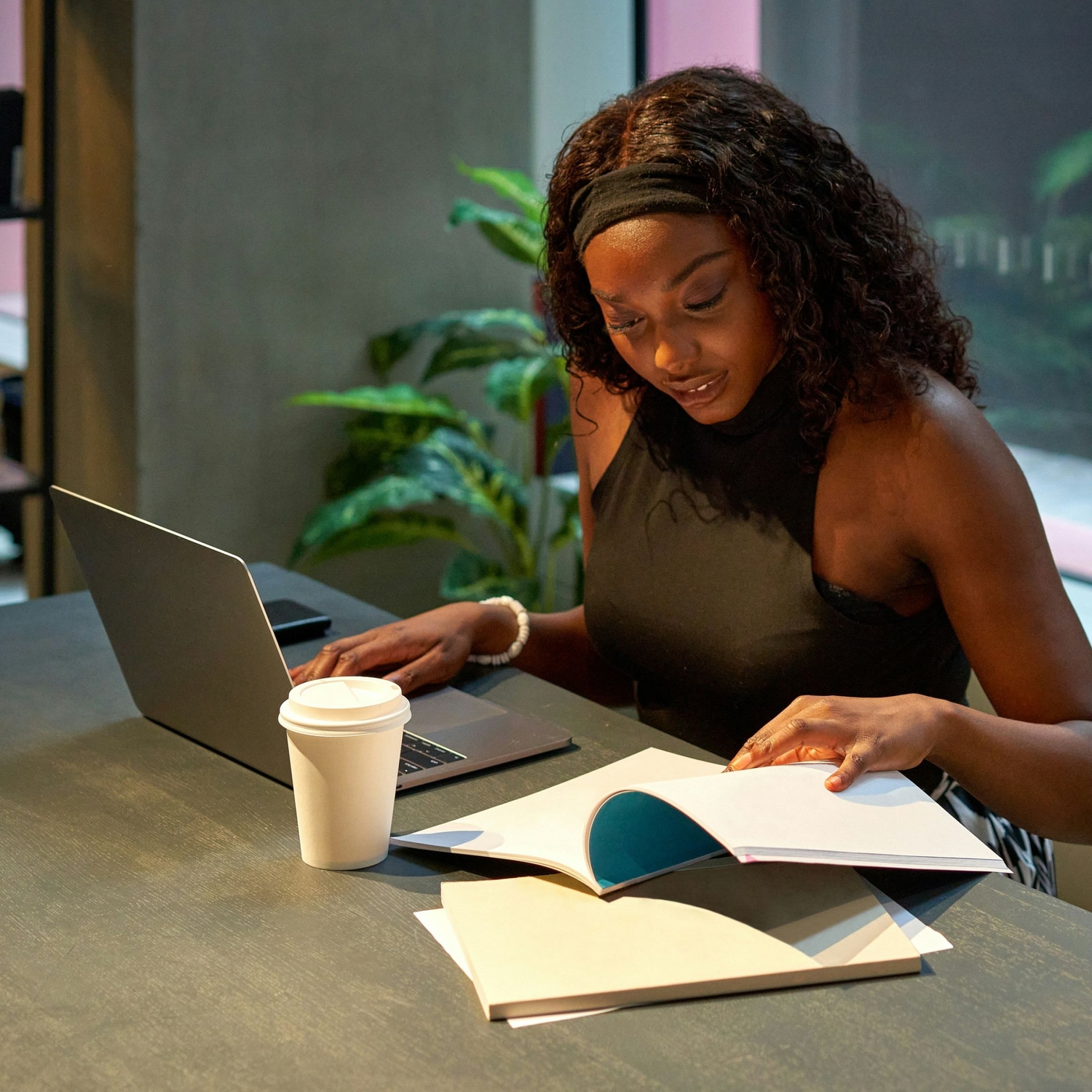 person writing therapist directory profile at desk with laptop