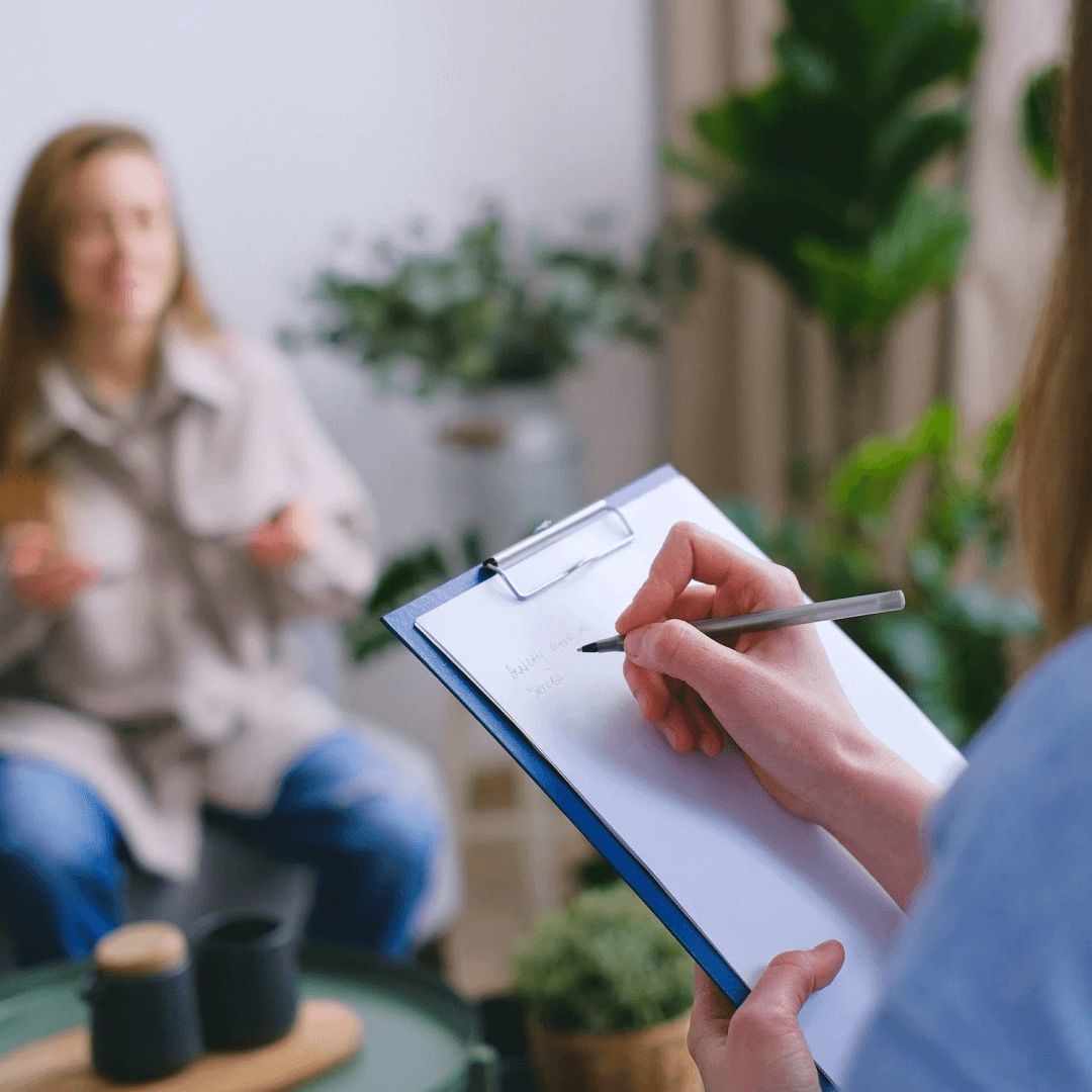 A female mental health clinician uses an adjustment disorder ICD-10 code during a session