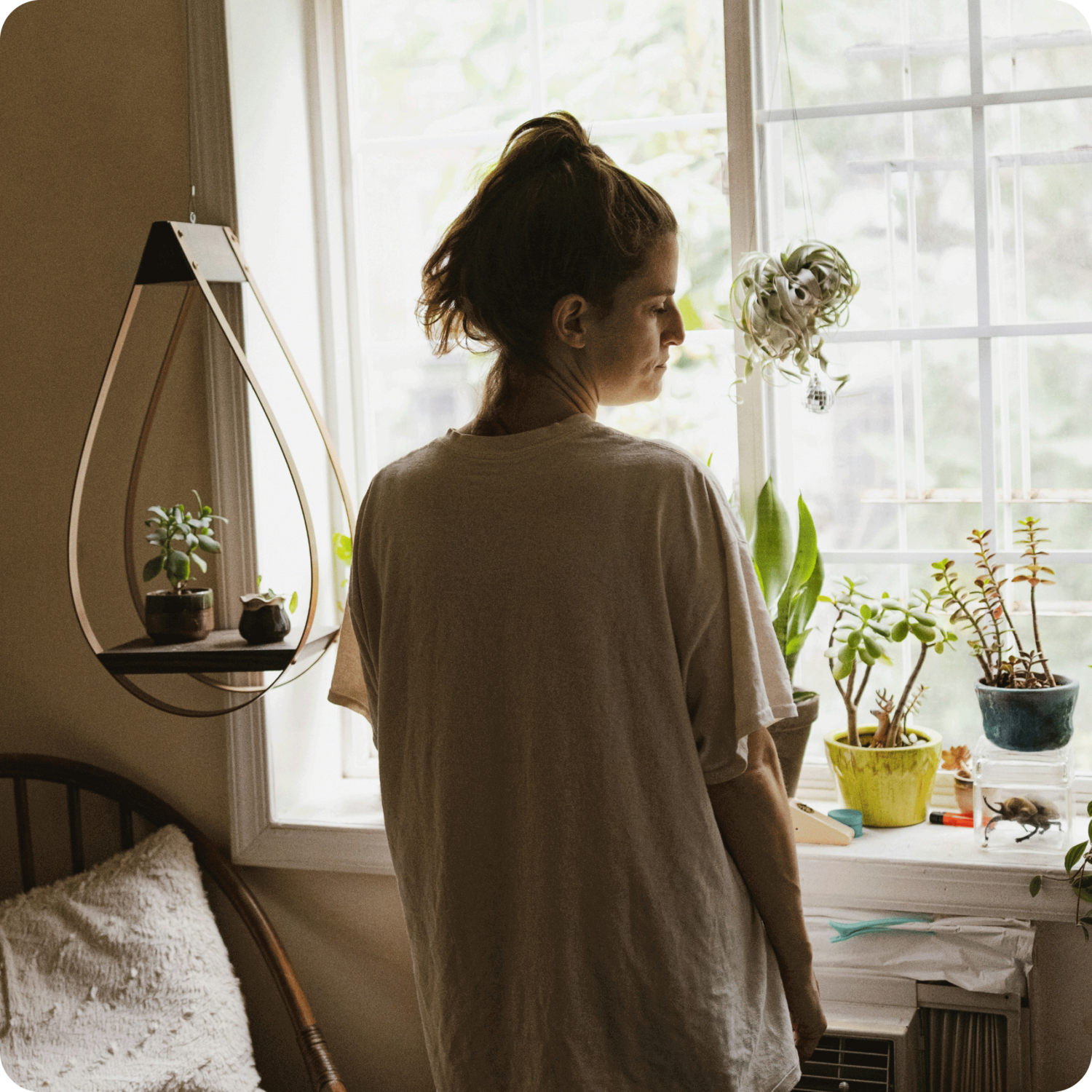 person standing in front of window using grief therapy worksheets