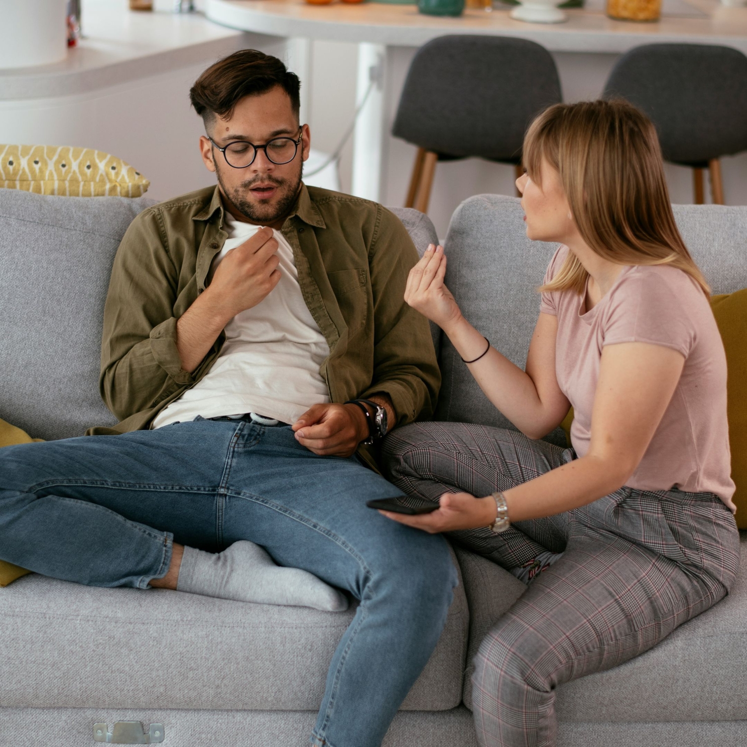 image of couple sitting on couch talking