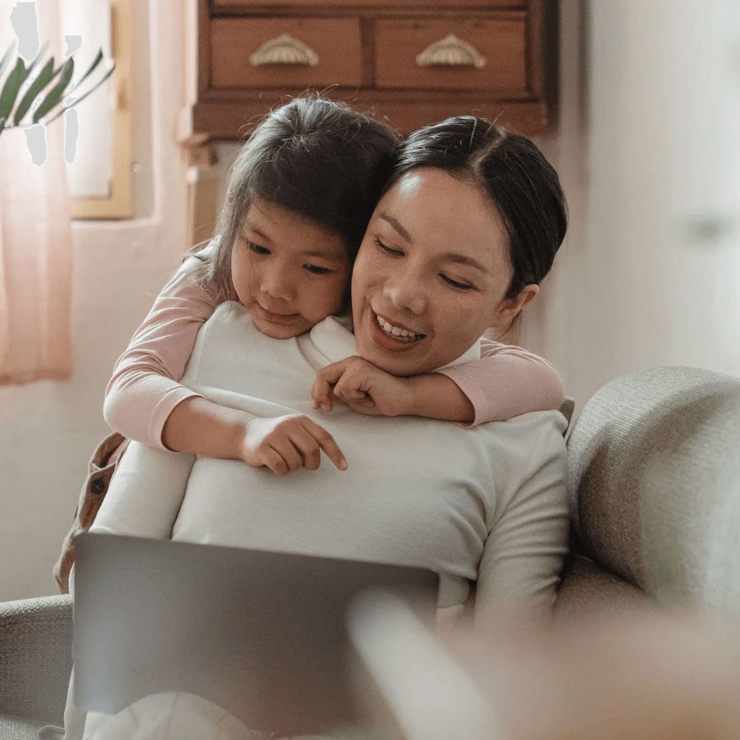 Mother sitting on couch uses the parent-child homework bundle for ots with her daughter