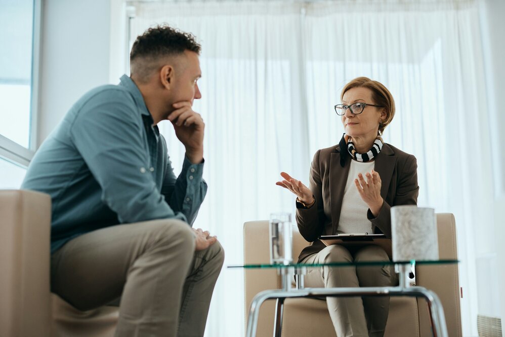 Nurse practitioner speaker with a patient in an office