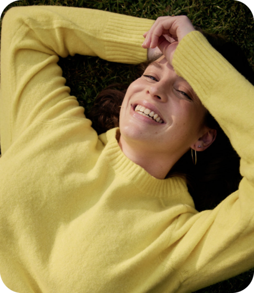woman laying on ground smiling