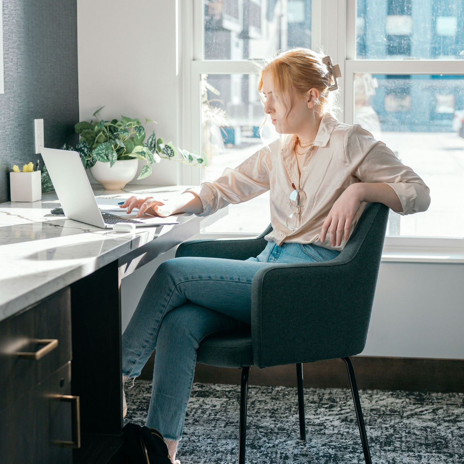 woman sitting at desk on computer in an office