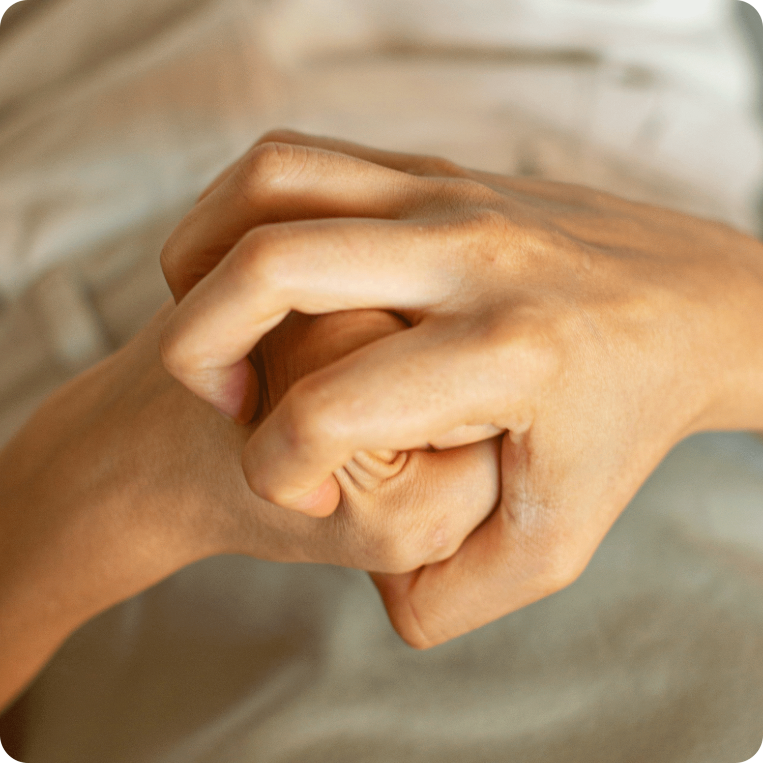 close up of person's hands in fists showing anger warning signs
