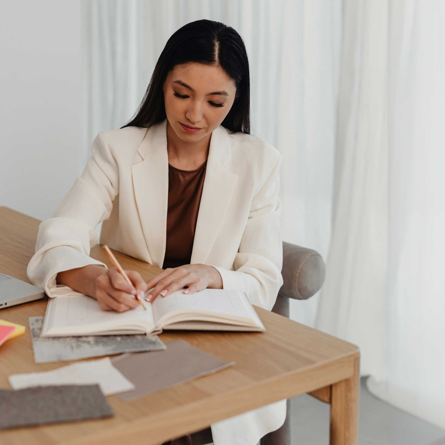 woman writing soap notes in notebook