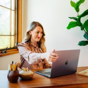 A female therapist searches for psychotherapy CPT codes on her laptop