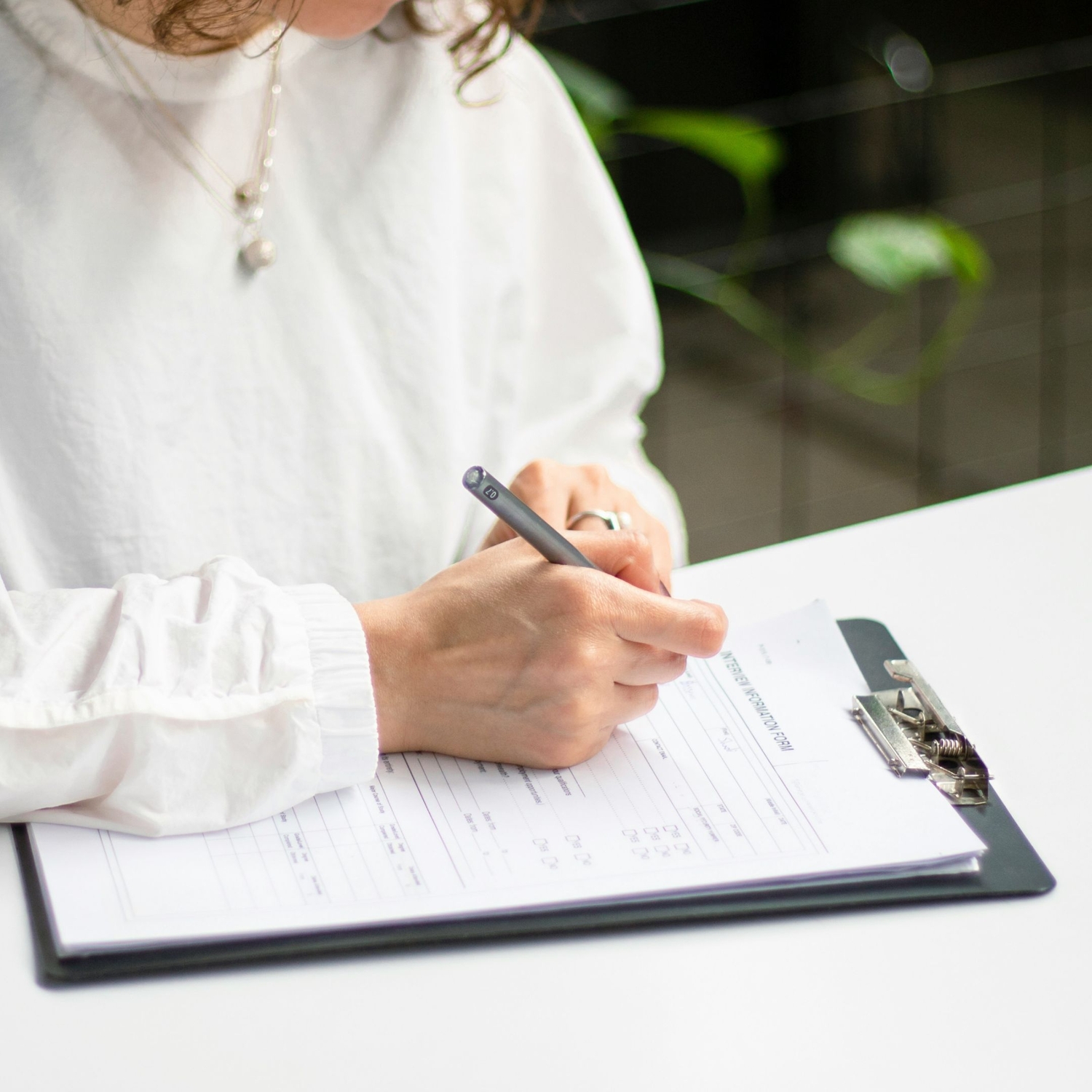 person filling out form during therapy intake process