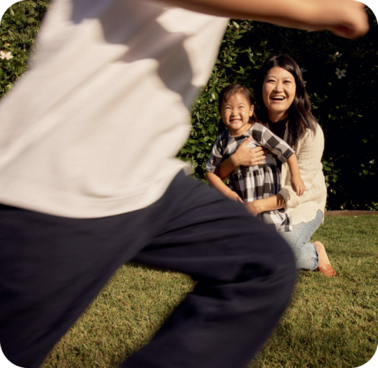 person running in foreground with woman and child in background